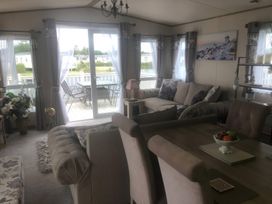 A living room with a sofa and a table at 62 Guddlebeck, Lakeland Leisure Park, Flookburgh