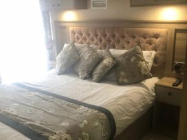A bedroom with a bed and pillows at 62 Guddlebeck, Lakeland Leisure Park, Flookburgh