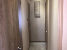 A hallway with doors and a sign at 62 Guddlebeck, Lakeland Leisure Park, Flookburgh