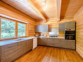A kitchen with cabinets and appliances at Foresters Spa Plus in Dundee