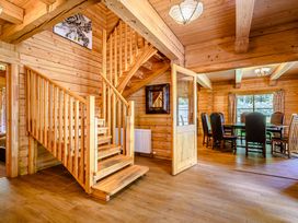 A dining room with a staircase and wooden furniture at Foresters Spa Plus in Dundee