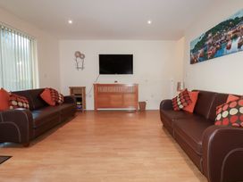 A living room with sofas and a television at 65 Benasa Lodge in Winnard's Perch near St Columb Major