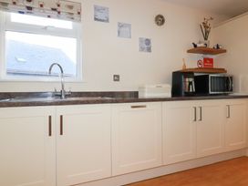 A kitchen with a sink and cabinets at 65 Benasa Lodge in Winnard's Perch near St Columb Major