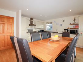A kitchen with a table and chairs at 65 Benasa Lodge near St Columb Major