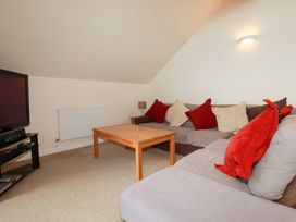 A living room with a sofa and coffee table at 65 Benasa Lodge near St Columb Major