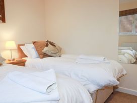 A bedroom with two beds and a nightstand at 65 Benasa Lodge near St Columb Major