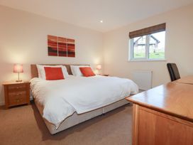 A bedroom with a bed and bedside table at 65 Benasa Lodge near St Columb Major