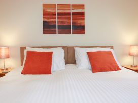 A bedroom with a bed and artwork on the wall at 65 Benasa Lodge near St Columb Major