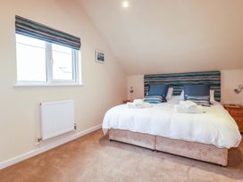 A bedroom with a bed and window at 65 Benasa Lodge in Winnard's Perch near St Columb Major