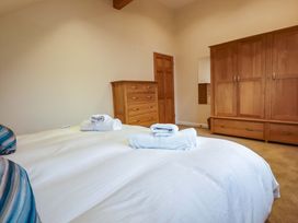 A bedroom with bed and furniture at 65 Benasa Lodge near St Columb Major
