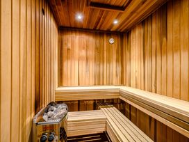 A sauna with wooden benches and a heater at Eagle Spa Plus in Dundee