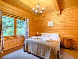 A bedroom with a bed and windows at Eagle Spa Plus in Dundee