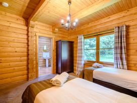 A bedroom with two beds and a wardrobe at Eagle Spa Plus in Dundee