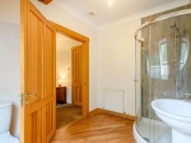 A bathroom with a shower and sink at Eagle Spa Plus in Dundee