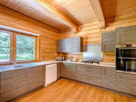 A kitchen with cabinets and appliances at Foresters Spa Plus (Pet) Dundee