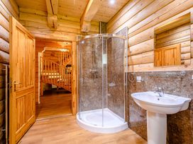 A bathroom with a shower and sink at Foresters Spa Plus (Pet) Dundee