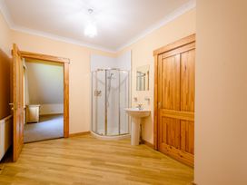 A bathroom with a shower and sink at Foresters Spa Plus (Pet) Dundee