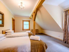 A bedroom with two beds and a window at Foresters Spa Plus (Pet) in Dundee
