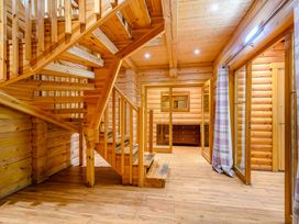 A hallway with a staircase and wooden furniture at Eagle Spa Plus (Pet) in Dundee