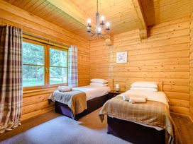 A bedroom with two beds and a window at Eagle Spa Plus (Pet), Dundee