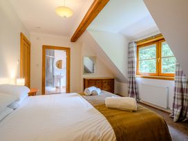 A bedroom with a bed and dresser at Eagle Spa Plus (Pet) Dundee