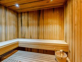 A sauna with wooden benches and a bucket at The Braveheart in Dundee