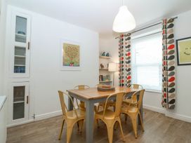 A dining room with a table and chairs at Mona Lodge in Llandudno