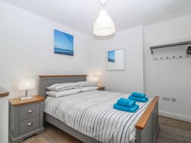A bedroom with a bed and a nightstand at Mona Lodge in Llandudno