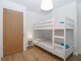 A bedroom with a bunk bed and a lamp at Mona Lodge in Llandudno