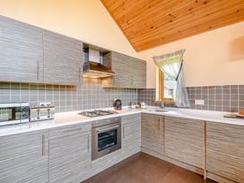 A kitchen with cabinets and appliances at Muirloch Spa Plus in Dundee