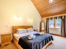 A bedroom with a bed and a window at Muirloch Spa Plus in Dundee