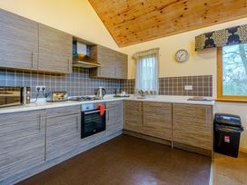 A kitchen with cabinets and appliances at Muirloch Spa Plus (Pet) in Dundee