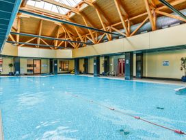 A swimming pool area with wooden beams at Muirloch Spa Plus (Pet) in Dundee