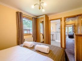 A bedroom with a bed and towels at Barnard Spa (Pet) Dundee