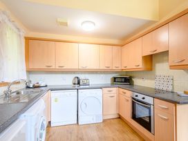 A kitchen with cabinets and appliances at Barnard Lodge (Pet) Dundee