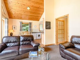 A living room with a sofa and table at Barnard Lodge (Pet) Dundee