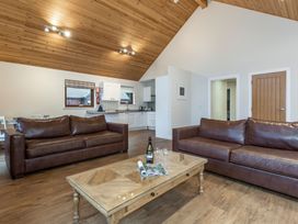 A living room with sofas and a coffee table at Raeburn Premier Spa in Dundee