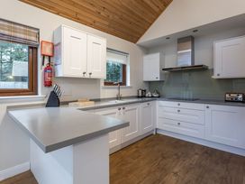 A kitchen with cabinets and appliances at Raeburn Premier Spa in Dundee