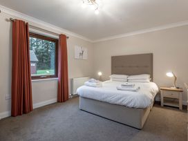 A bedroom with a bed and window at Raeburn Premier Spa in Dundee