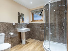 A bathroom with a toilet, sink, and shower at Rainbow Spa Plus in Dundee