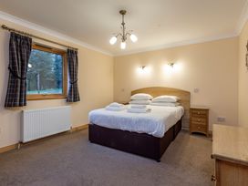 A bedroom with a bed and window at Rainbow Spa Plus in Dundee