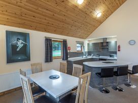 A kitchen with dining table and chairs at Rainbow Spa Plus (Pet) in Dundee