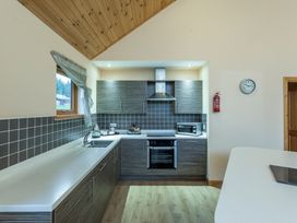 A kitchen with cabinets and appliances at Rainbow Spa Plus (Pet) Dundee