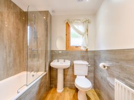 A bathroom with a shower and bathtub at Osprey Lodge in Dundee