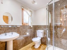 A bathroom with a sink, shower, and toilet at Osprey Lodge in Dundee