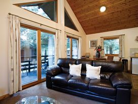 A living room with a sofa and dining area at Osprey Spa Dundee