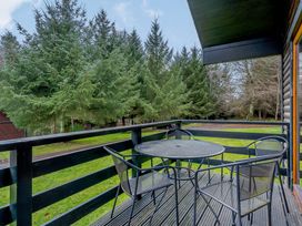 An outdoor area with a table and chairs at Osprey Lodge (Pet) Dundee