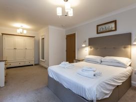 A bedroom with a bed and wardrobe at Galbraith Premier Spa in Dundee