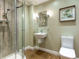 A bathroom with shower, sink, and toilet at Galbraith Premier Spa in Dundee