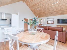 A living room with a table and chairs at Galbraith Premier Spa in Dundee
